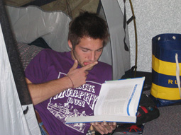 Kyle Brown studies in his tent
