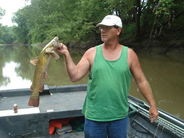 Haul it in Neil Womack, Cat Daddys nephew, holds a flathead catfish the crew caught Aug. 28. Womack came up from his home in Arkansas to fish with his uncle.
