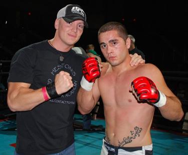 Scott Heston (on left) poses with Zeph Martinez, a fighter at Heston's Gladiator Academy.
