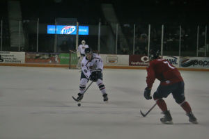 Jacob Poe holds on the puck in along the blue line Saturday night. Poe scored a rare goal and helped propel Topeka to a 5-4 victory 