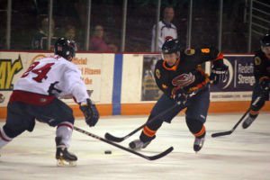 Nate Milam tries to carry the puck into the offensive zone during Friday night's game. Topeka fell though, despite leading going into the third period. 