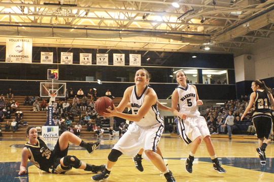 Junior forward Dana Elliot looks to score against Emporia State during a regular season game. Elliot led the Lady Blues with 18 points against West Texas A&M University in the first round of the NCAA Playoffs. Washburn won 68-36 and will wait to see who they play next.

