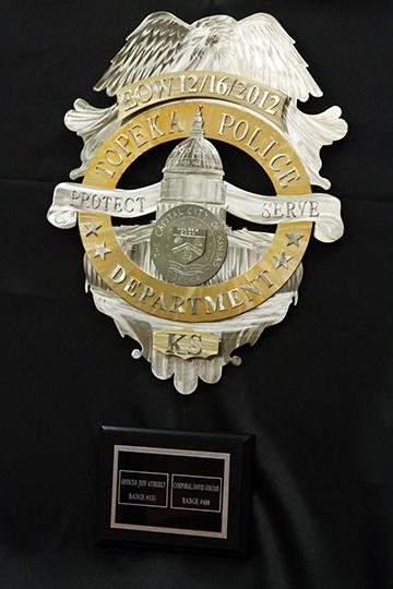 Renee Johnsons police badge donated to the Topeka Police Department commemorates the fallen officers. Johnson wishes that every person in service could have their own badge. 
