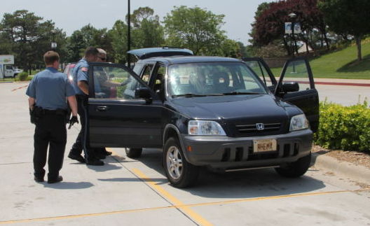 Washburn University police officers checking the car for finger prints.
