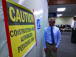 Sean Bird studies the authorized personnel only sign. The construction at Mabee is limiting space to students. 