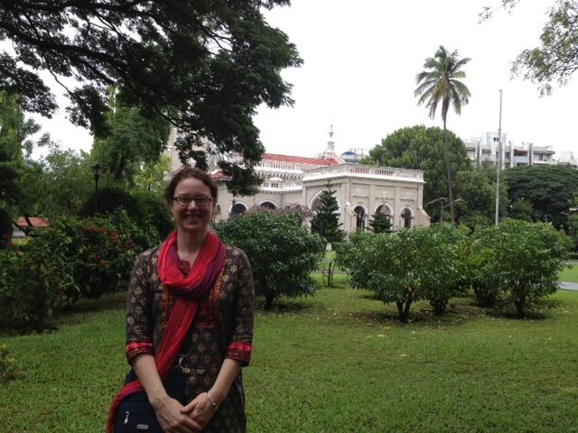 Professor Tonya Kowalski stands in front of Aga Kahn Palace in Pune, India.