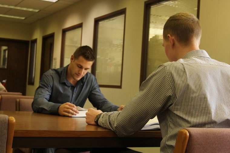 Law school requires much research, reading and writing. First year Washburn law students Marty Pfannenstiel and Bobby Chipman credit sports training for helping them learn the time and stress management skills essential for intense study.