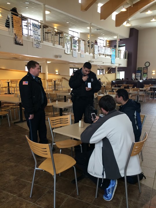 Officers Marcus Herrera and Andrew Putnam asking Raymond Vawter about his condition after his fall on ice. Students can view police reports filed at the WU Police office when open or read reports every week in the Washburn Review.