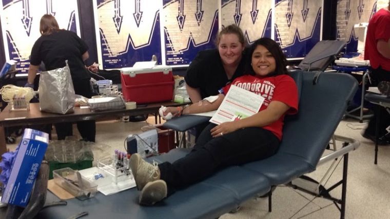 Blyth Johansen and Bianca Martinez, president of HALO, encourage students to donate blood.