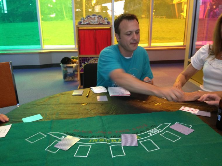 Kyle Morris, floor manager and program developer at the Discovery Center, deals out some cards for a non-gambling game of blackjack. The game was played due to the random nature of the cards demonstrating both luck and probability.