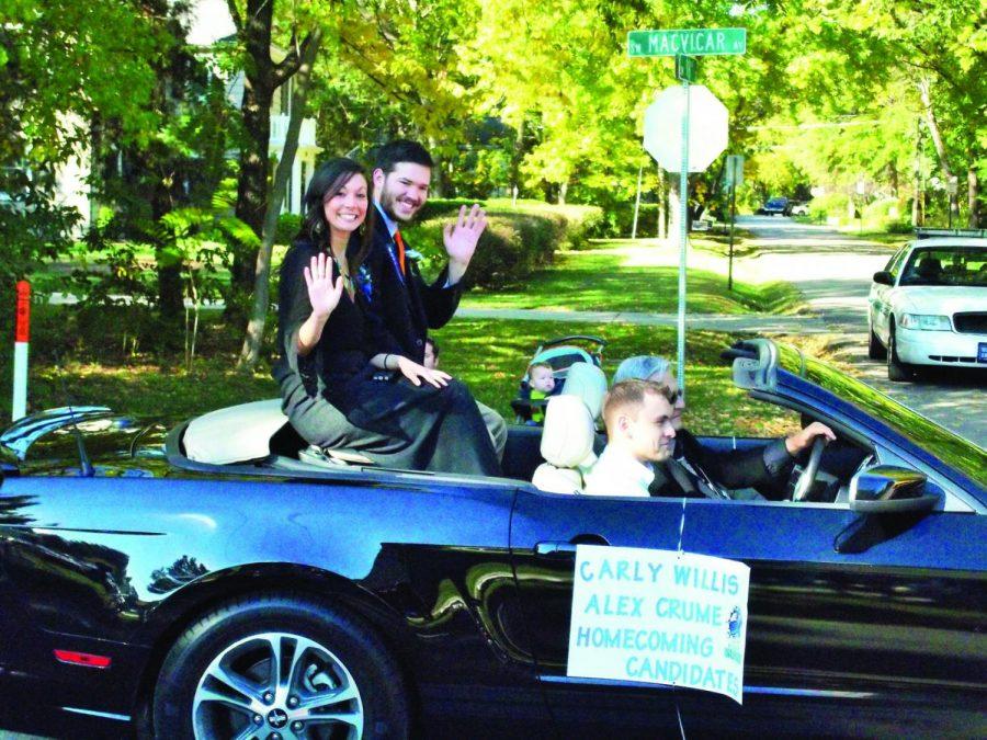 Soon-to-be Homecoming King Alex Crume, math education major, and Queen Carly Willis, senior mass media, wave to parade watchers on MacVicar Avenue.