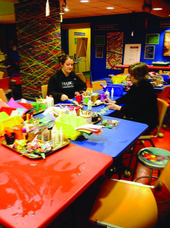 CELEBRATING ART: Kandis Barker, curator of education at the WU Art Lab, creates artwork after being visited by an elementary school. The Mulvane hosts many elementary schools throughout the community to visit and teach them art lessons.