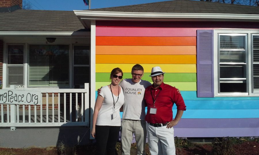 Director of Operations Davis Hammet (Middle) stands with two NOH8 volunteers in front of Equality House, as locals have their photos taken inside.