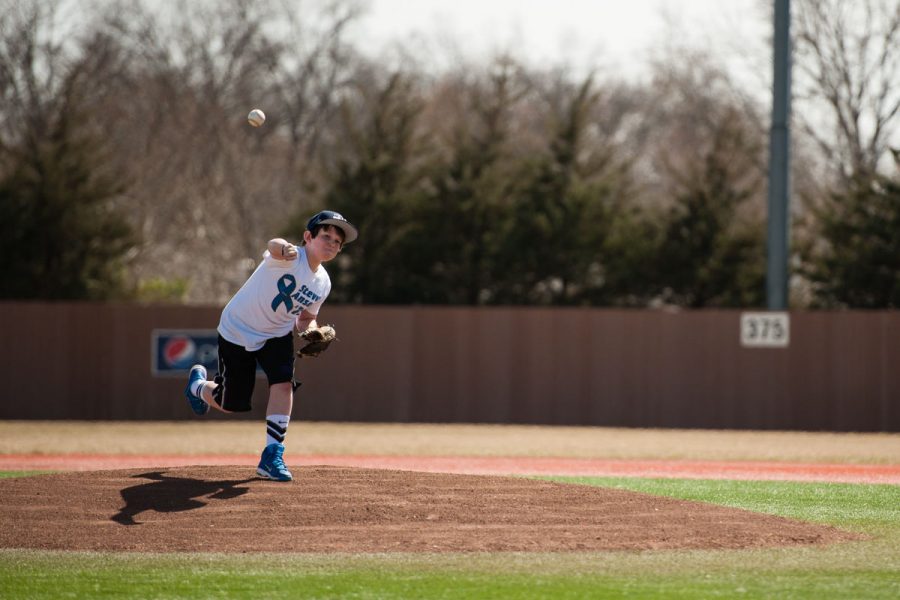 Steve Ansons grandson Seth throws the first pitch of Washburns game against Emporia State. Washburn won, 6-1.