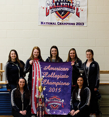 Dancing Their Way to Victory: Members of the Dancing Blues dance team [bottom left to right] Katherine Matthews, Bailey Turner, [top left to right] Lexi Lemons, Radie Keller, Monica Conaway, Mackenzie Stultz and Amelia Wynn pose with their trophy and championship banner after placing first at this year’s College Dance Teams American Collegiate Championship.