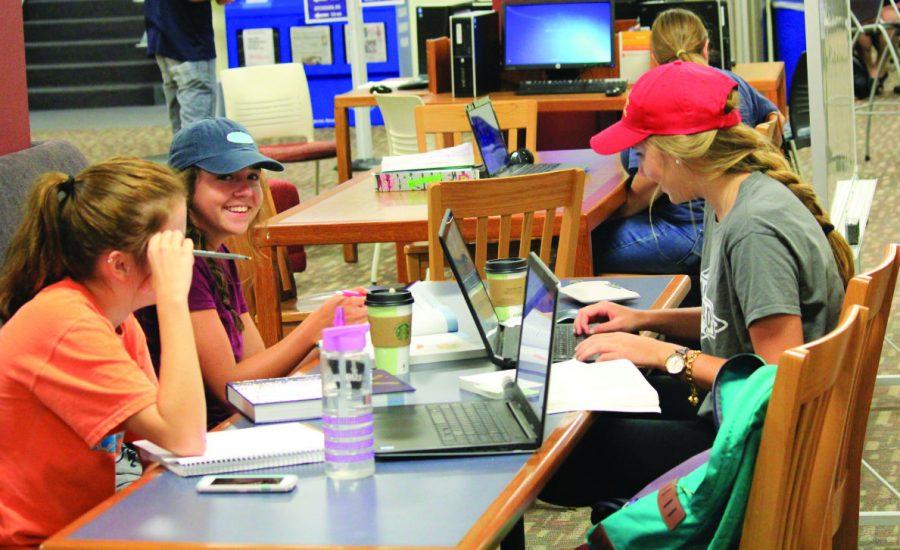 Students work in the library during the daytime.