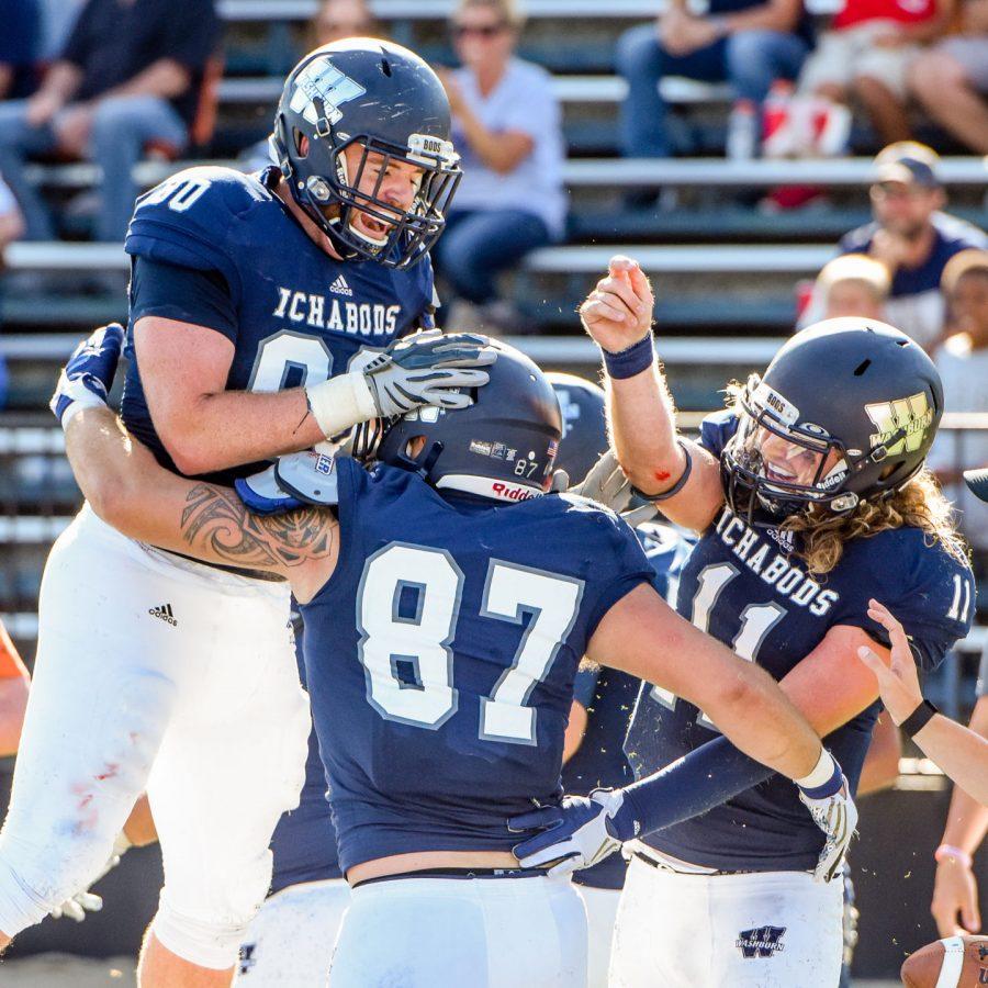 Luke Yoder, Adam Luthi, and Derek McGinnis celebrate in the end zone after a successful two-point conversion against Missouri Southern.