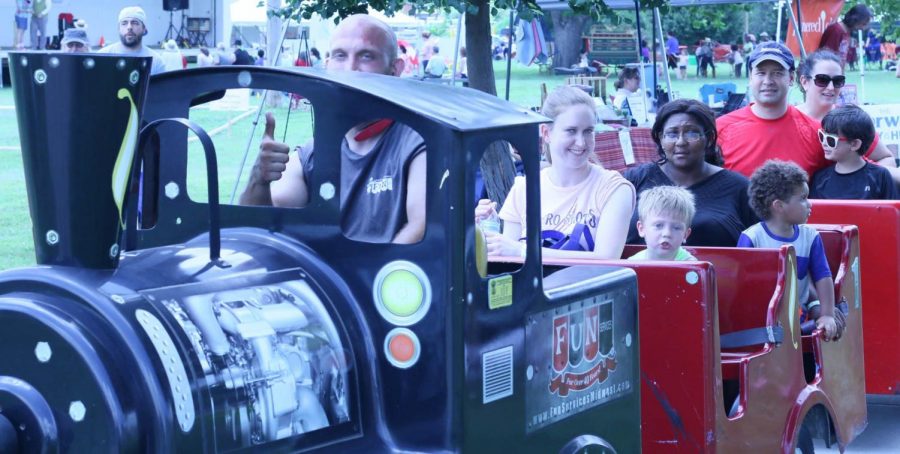 Attendees riding a mini-train. The mini-train offered rides throughout the event.