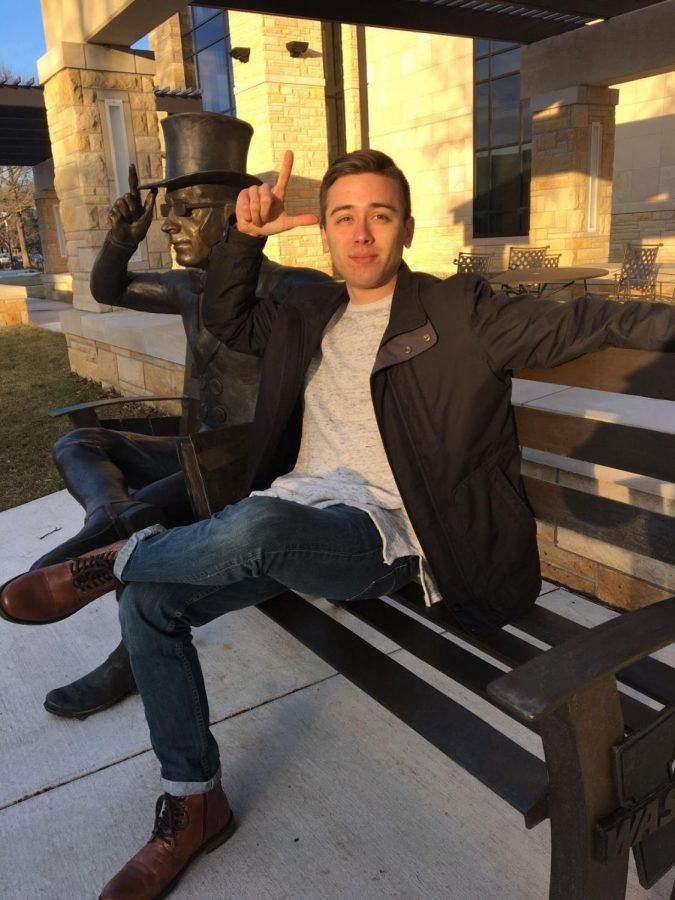 The New Classic: Ryan Yowell, sophomore psychology major, shows off an effortlessly cool look with a fitted grey sweater, dark wash jeans and sleek black jacket. These classic style staples are great for date nights.