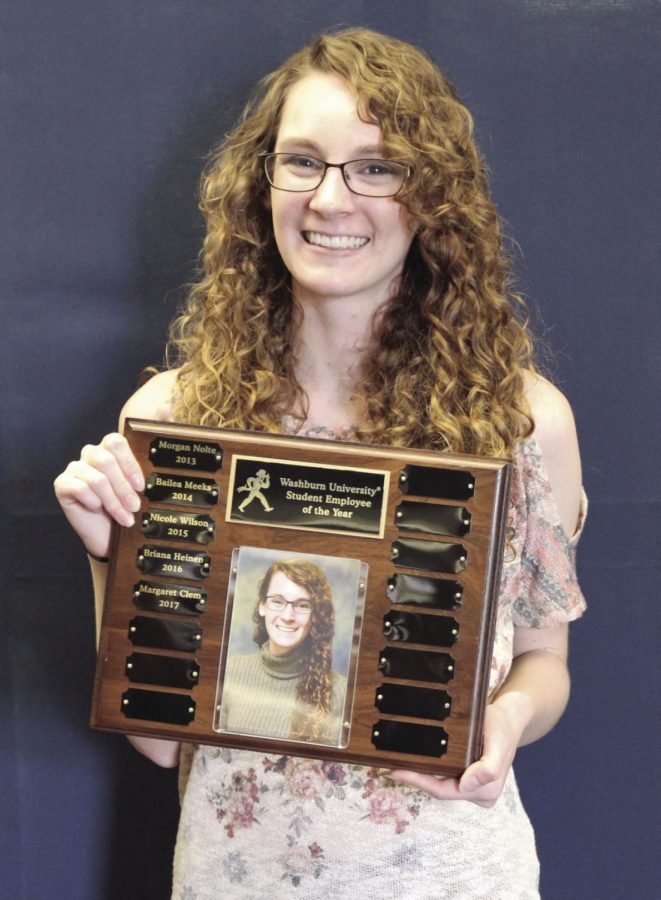 Margaret Clem, senior graphic design major, posing with her award for Student Employee of the Year. Clem won the award for her hard work at the Ichabod shop.
