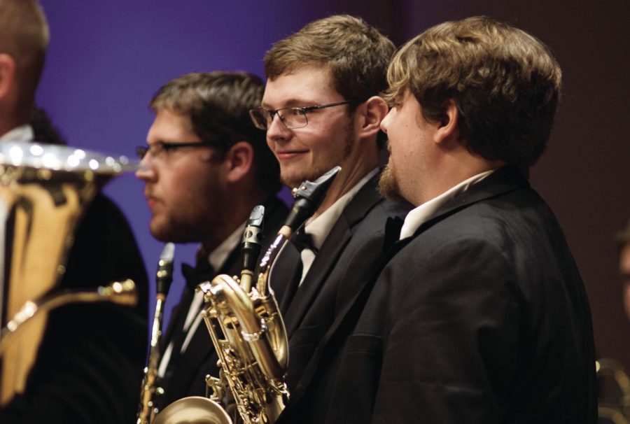 (From left to right) Josh Griffin, sophomore music education major, Jacob Brooks, senior music performance major, and Jason Lewin, senior music education and performance major, share a cheeky smile during the Wind Ensemble’s performance of “Magnolia Star” by Steve Danyew. The three are also brothers of Phi Mu Alpha who performed “Ode,” a song from the fraternity’s repertoire at the Mosaic concert. 