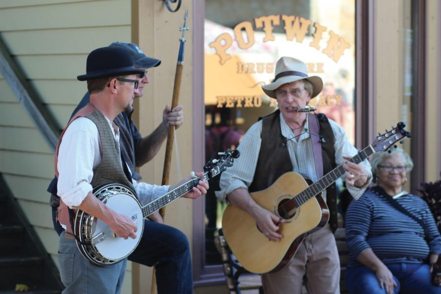 Pickin’ and a grinnin: A group of musicians perform bluegrass music in old time costume. The trio was one of several bands at The Apple Festival that participated in the Wheatstock music concert.
