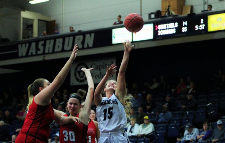 Under pressure: junior, Alexis McAfee shoots with defensive pressure against an MIAA conference opponent in Lee Arena.
