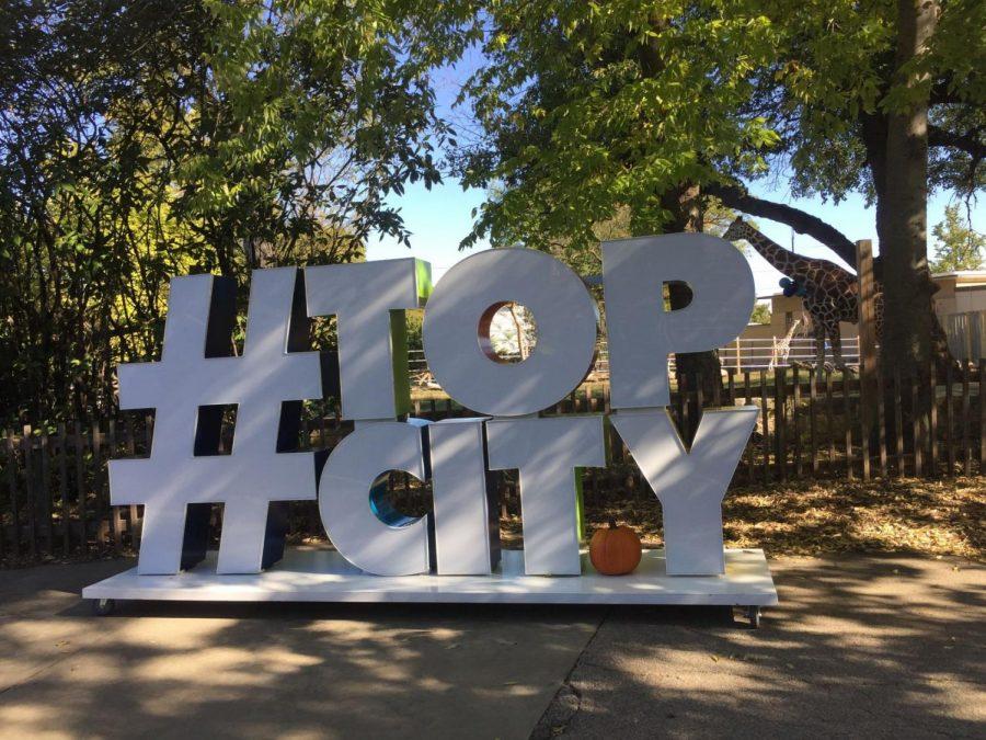 Youre having a giraffe!: Giraffes, Sarge (front) and Hope (back), pictured behind the #TOPCITY photo booth sign. The Topeka Zoo and Conservation Center hosted Boo at the Zoo, an annual event which attracts thousands of families for Halloween and other fall activities. 