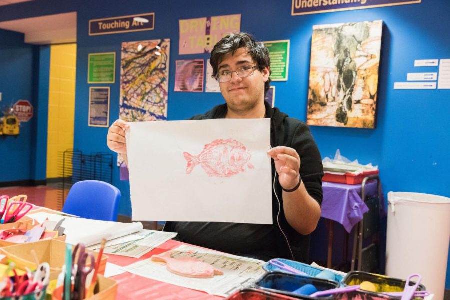 Fish printing: Errick Guzman is a  sophomore history major with an emphasis in education. He helped people to make Gyotaku in the Art Lab.
