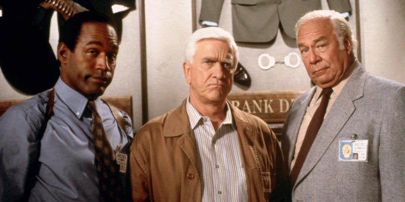 A Comedy Masterpiece: The Naked Gun is a wonderful film, thoroughly enjoyable and it absolutely deserves all the love it gets with the crucial element being Leslie Nielsens performance as Frank Drebin. Pictured are Police Squad members Nordberg (O.J. Simpson), Lt. Frank Drebin (Leslie Nielsen) and Captain Ed Hocken (George Kennedy).