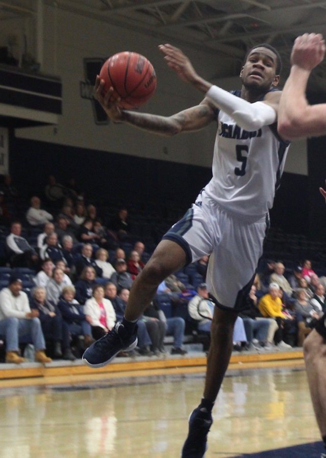 Drawing contact: Senior guard Javion Blake drives to the basket in an attempt to score. Blake is in the top 5 of all-time scorers in Washburn history.