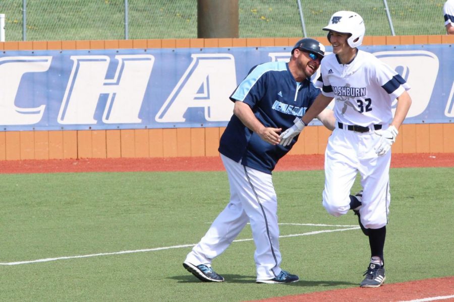 Dinger: Freshman Chance Ragsdale gets a high five and a smile from head coach Harley Douglas as he rounds third after hitting a home run. The home run was the first of Ragsdales college career.