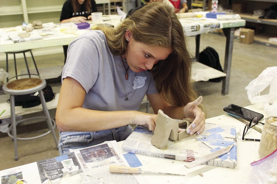 Sole creator: Rowan Poovey works diligently on her clay high heel in Ceramics I. Poovey is a freshman elementary education major.