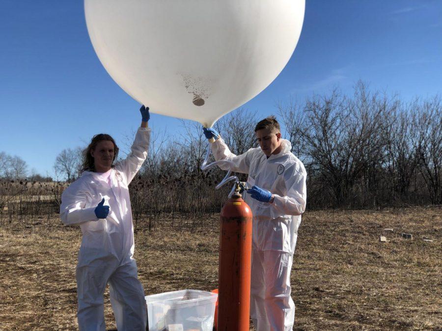 Sculpture in motion: The aeronautical visual arts program is creating sculptures that fly and document the landscape. Benjamin Will (right) launched his aeronautic project Pissarro balloon in Topeka Dec. 20, 2018. Isaac Bird (left) assisted him.