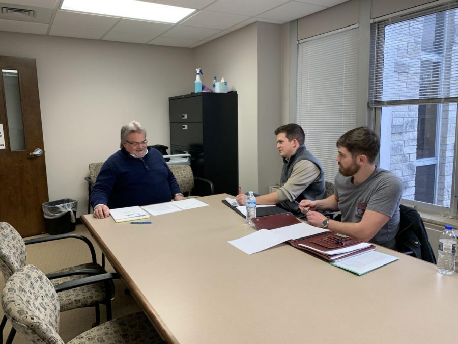 In the zone: Law students David Braun and Nick French practice their client cooperation skills with their coach Dean Shawn Leisinger. This will be the first competition for Braun and the second for French. 