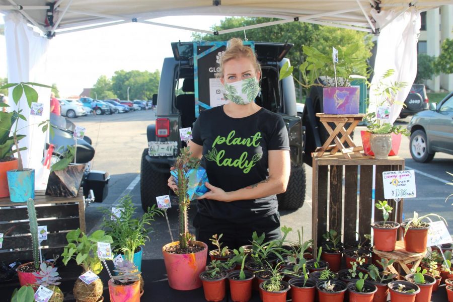 Ashley McDonald posing with her Glo Bowl stand where she sold plants and homemade pots. She and her family enjoyed coming to the Farmer’s Market to sell their wares.