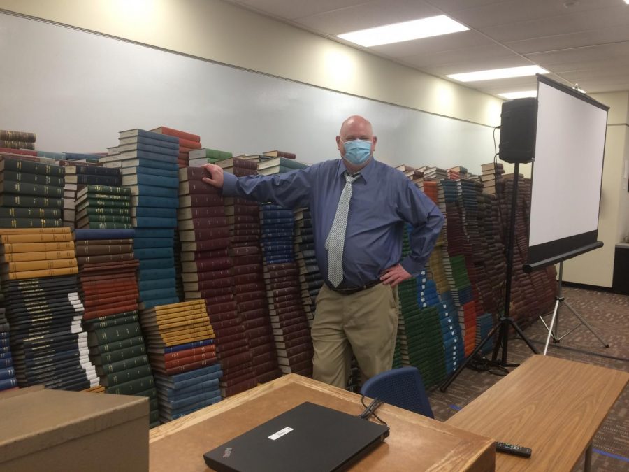 Tall as a Book: Library Dean, Dr. Bearman stands proud. The Dean explained that it was quite a chore moving all the books to the basement.