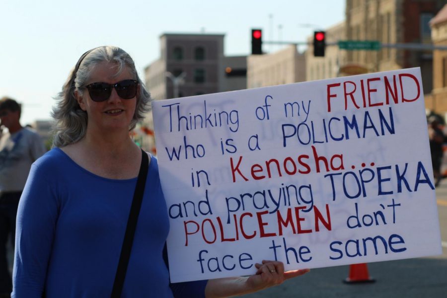Community member Karen Pope holds a message at her side at TPAC to show support for local policemen.