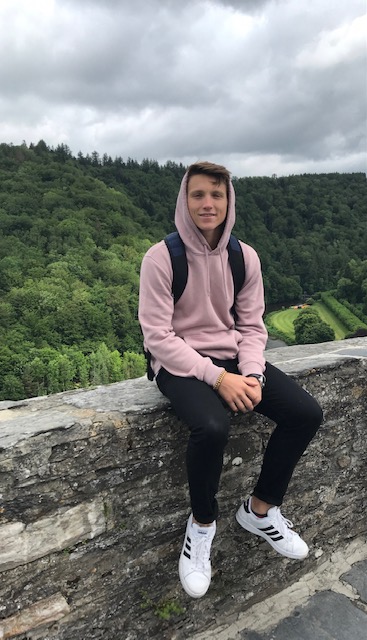 Dont Fall!: Chase Brill sitting on the ledge of a fortified castle in France. He and his classmates found plenty of good photo opportunities here.