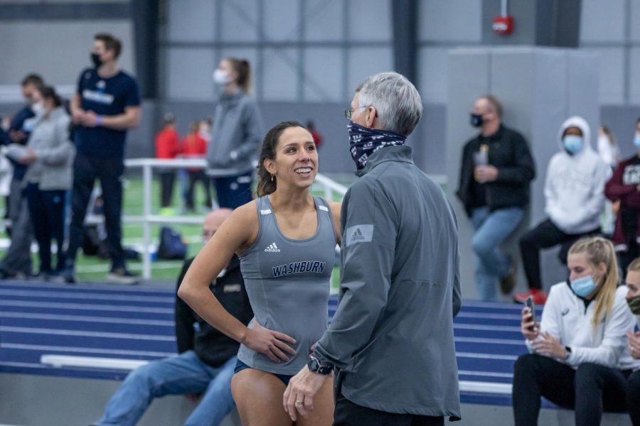 Run fast, vault high: Washburns senior pole vaulter Virgi Scardanza talking with assistant coach Rick Attig after a great vault. She always gives 100% each time she pole vaults.