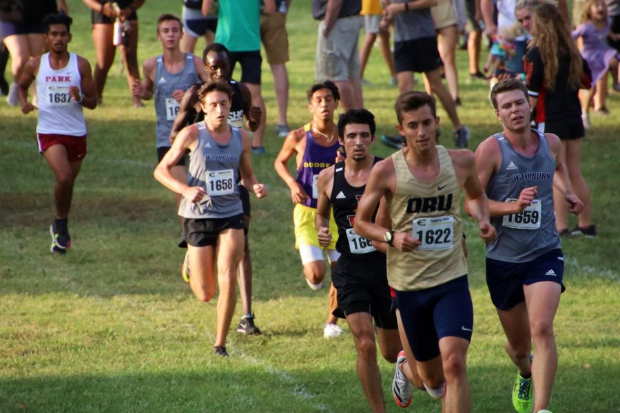 Long Road: Brett Kulp, Cooper Griffin and Nick Petrella all run in a pack with several other competitors nearing the end of a long race. Bret, Cooper and Nick go on to earn 27, 31, and 33 points for the team respectively.