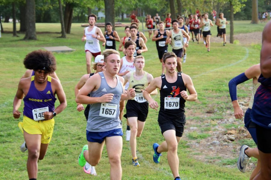 running strong: Troy Gabert runs strong and confident around corner 8. Troy will finish with a time of 31:06.5 earning 55 points for the team.