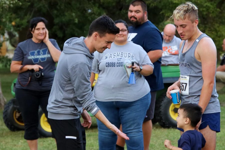 XC is a Family Sport: David Granato interacts with Troy Grabert's family while discussing how Troy felt during the race. Troy ran a tome of 331:06.5, earning 55 points for the team.