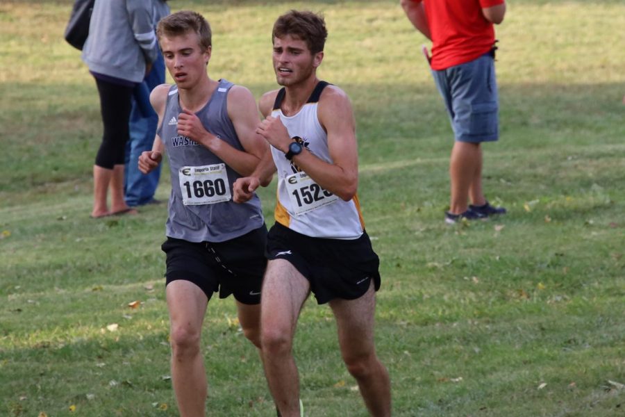 Working Together: Gustav Morch and a Fort Hays runner work together to maintain their position in the hopes to outrun the competition. Gustav Morch finished first for the Ichobods, earning 23 points for the team.