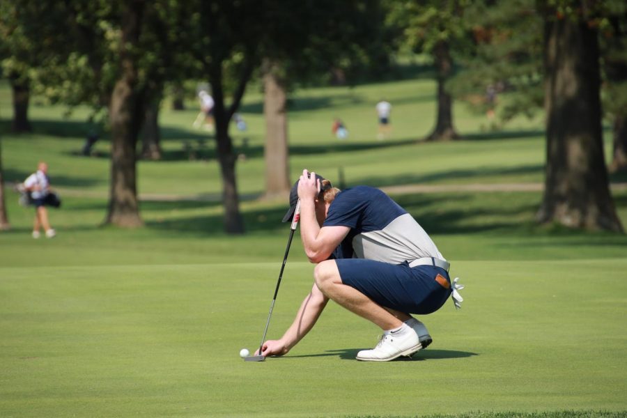 Steady does it: Junior Dawson Wills lines up his shot before making a put on September 13, 2021 at the Washburn Invitational. Wills finished in first place with a score of 211 over both days.