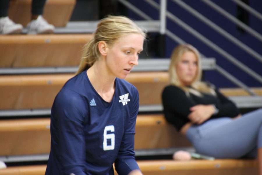 See ball hit ball: Senior outside hitter Taylor Antonowich prepares to make a serve in the first set on Oct. 1, 2021. Antonowich finished with 12 digs in the match.