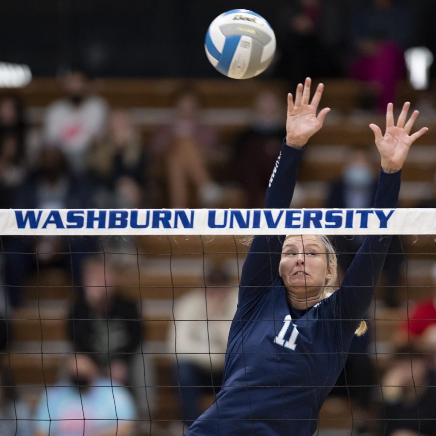 Get high: Washburn middle blocker Sydney Fitzgibbons reaches for a block Thursday, Oct. 21, 2021, at Lee Arena in Topeka, Kansas. Fitzgibbons assisted on three blocks in the match.