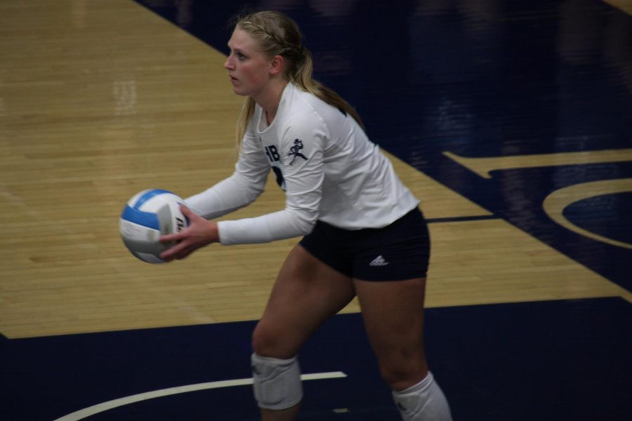 Lob it up: Senior libero Faith Rottinghaus  prepares to throw the ball up on a serve on Oct. 1, 2021. Rottinghaus finished with 14 digs in the match.