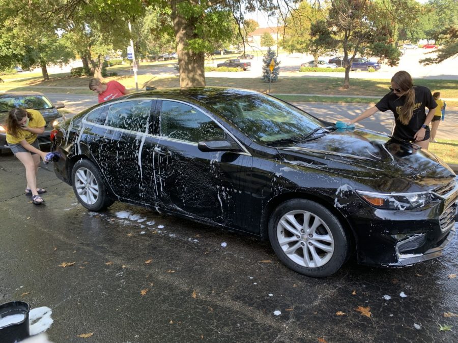 Squeaky Clean: Delta Gamma members putting in the work to clean the line of cars. The $5 car wash was the first event of many for their philanthropy week.