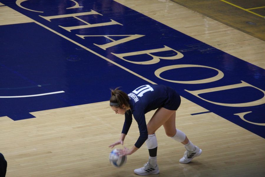 Routine: Freshman outside hitter Jalyn Stevenson bounces the ball before making a serve on Oct. 1, 2021. Stevenson finished with a game-high of 9 kills in the match.